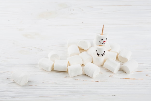 Free Photo small snowman made from marshmallows on table 