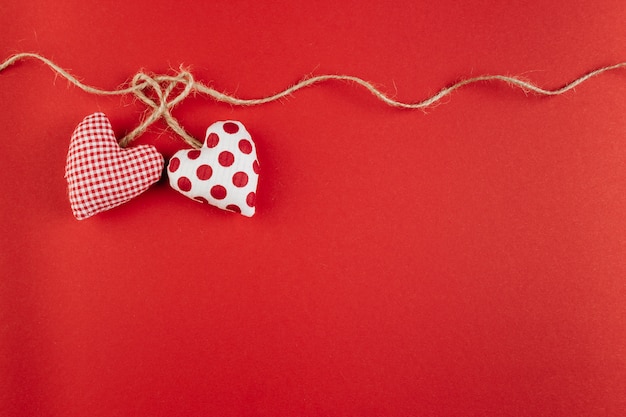 Free photo small soft hearts with rope on table