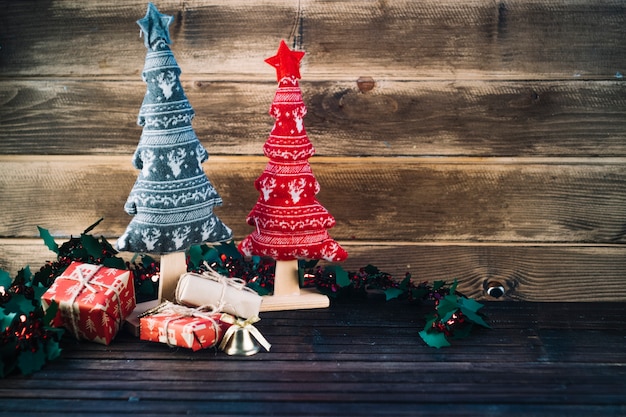 Small toy Christmas trees on table