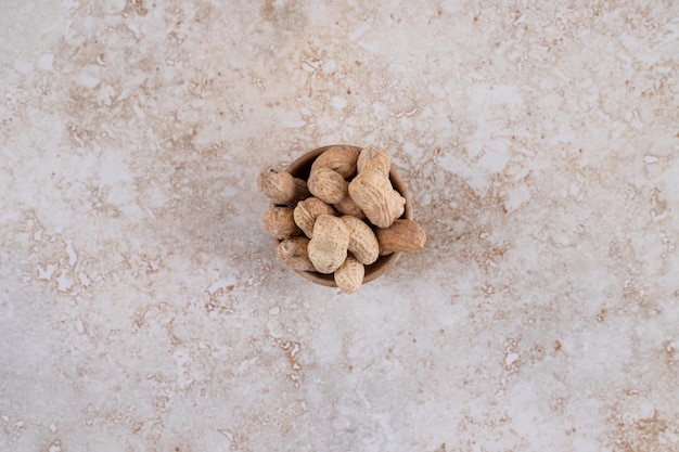 A small wooden bowl full of healthy cashew.