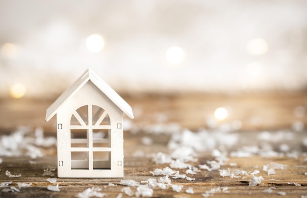 Small wooden house on a blurred background with bokeh Christmas background