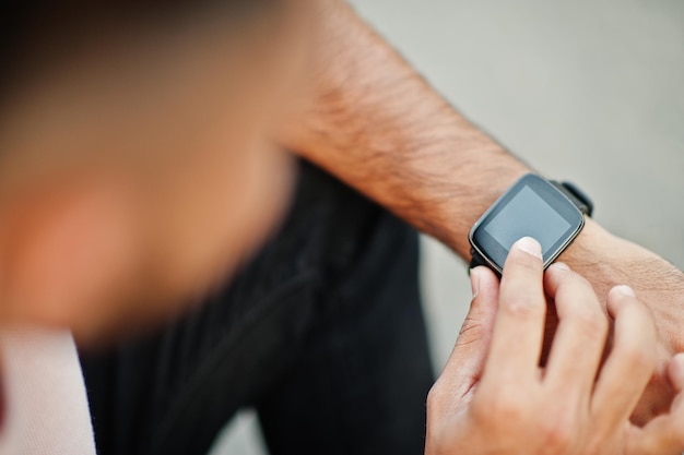 Free Photo smart black watch on the boy's hand from above