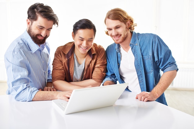 Smart businessmen discussing the project on laptop