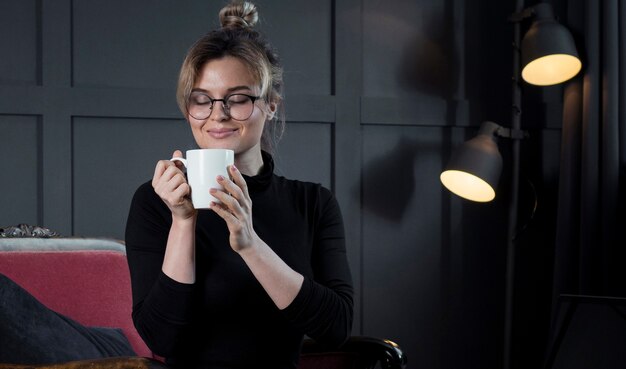 Smart businesswoman having a cup of coffee