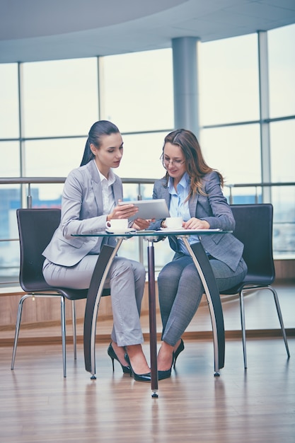 Smart businesswomen working with a tablet