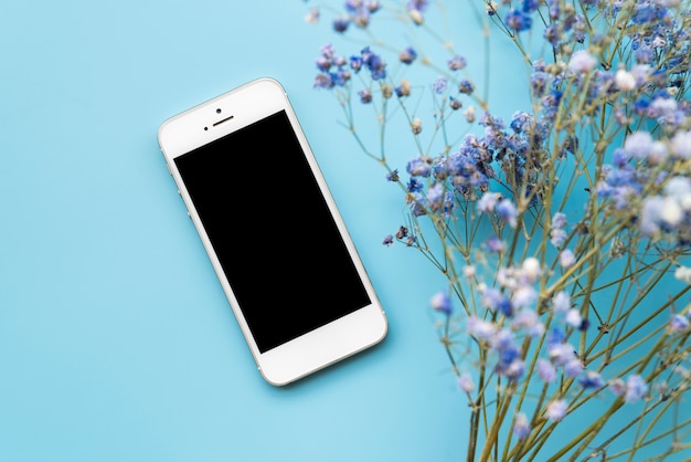 Smartphone and fresh flower twigs