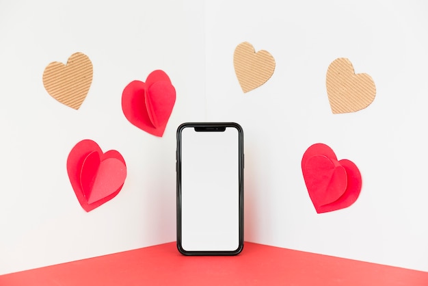 Smartphone with small paper hearts 