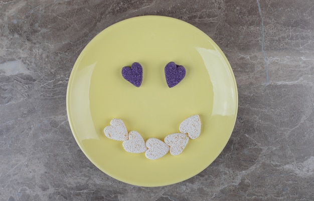 Free photo smile picture made from cookies on the plate, on the marble surface