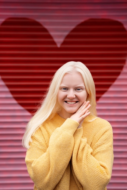 Free photo smiley albino woman outdoors front view