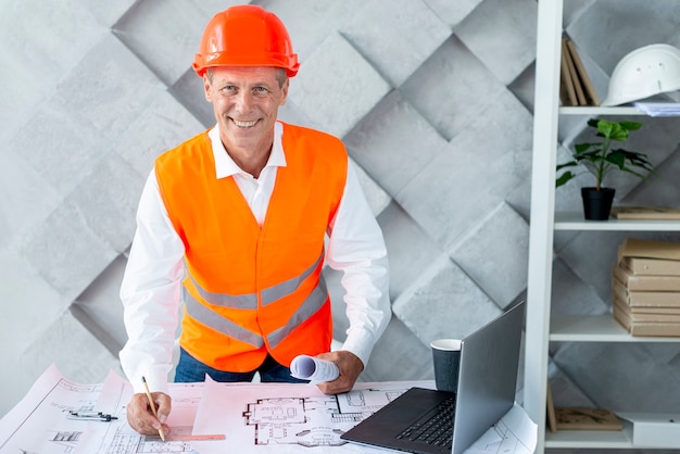 Smiley architect wearing his safety equipment 