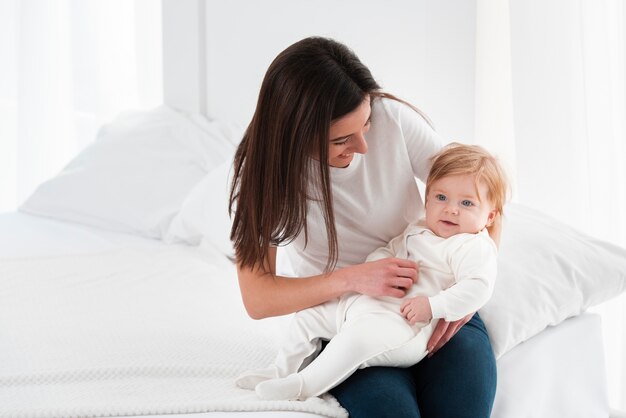 Smiley baby being held by mother