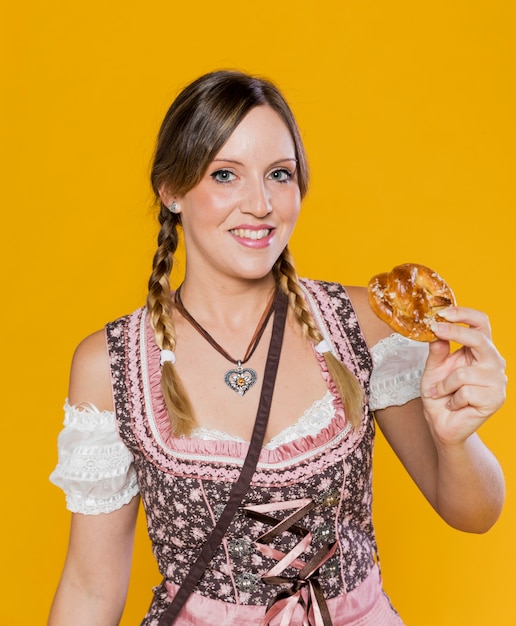 Smiley bavarian woman with pretzel