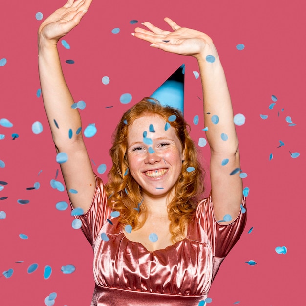 Free photo smiley birthday girl throwing confetti