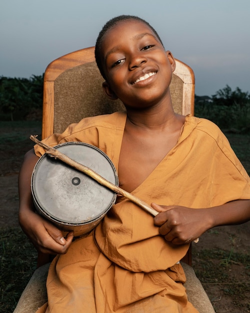 Free Photo smiley boy playing drum