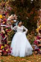 Free photo smiley bride posing with flowers front view