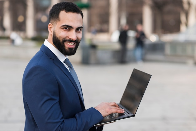 Smiley business male with laptop