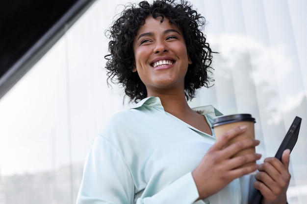 Smiley business woman holding coffee cup