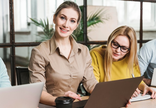 Smiley businesswoman posing during a meeting indoors