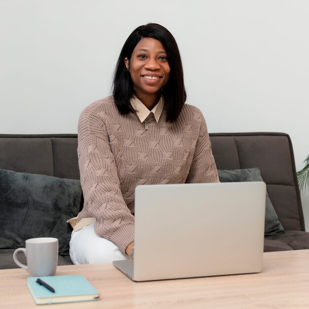 Smiley businesswoman working on a laptop