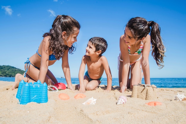 Smiley children playing on the beachq