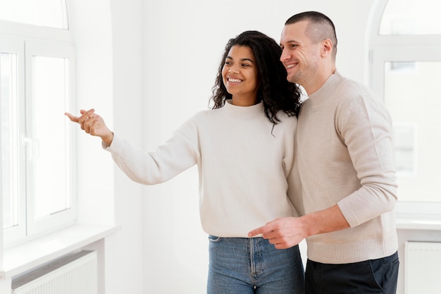 Smiley couple enjoying their new house