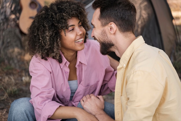 Smiley couple outdoors getting romantic