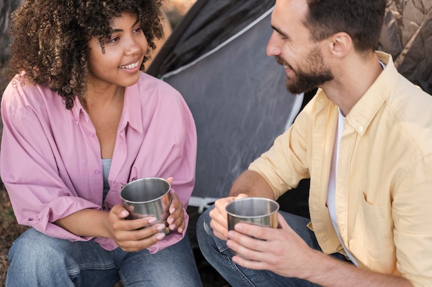 Smiley couple outdoors having a drink