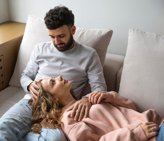 Smiley couple relaxing at home