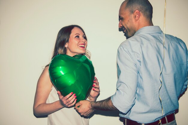 Smiley couple with a balloon