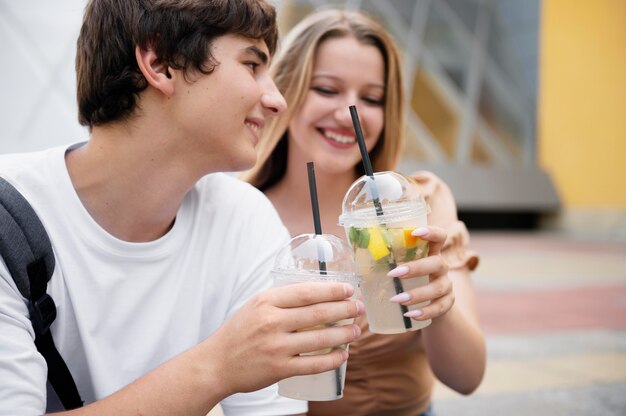 Smiley couple with drinks close up