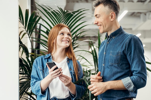 Free Photo smiley coworkers looking at each other