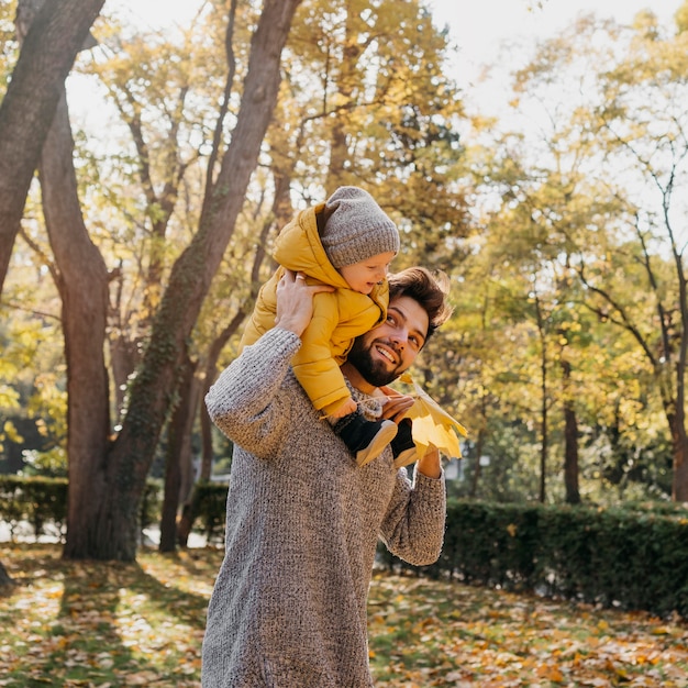 Smiley dad with his baby outdoors in nature