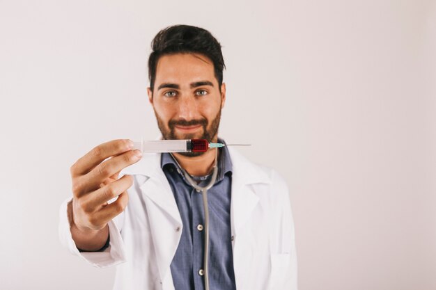 Smiley doctors holding a syringe