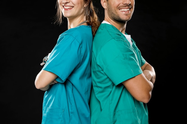 Free photo smiley doctors posing back to back