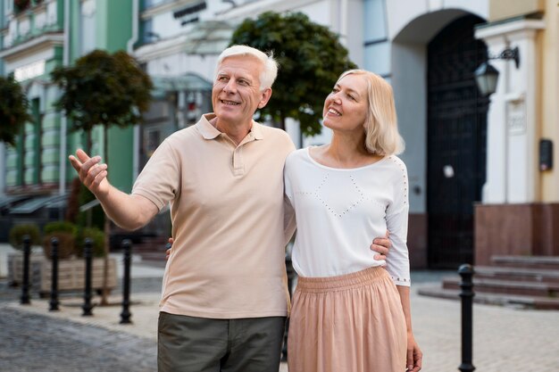 Smiley elder couple taking a walk outdoors in the city