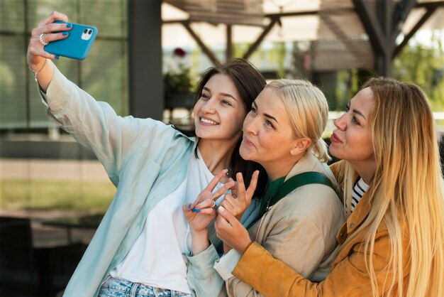 Smiley family taking selfie medium shot