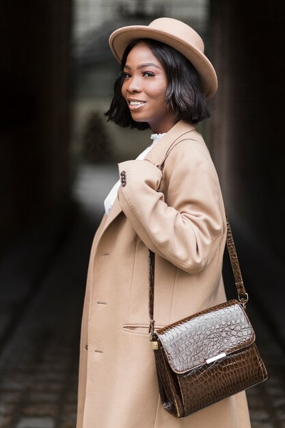 Smiley fashionable woman model posing while standing