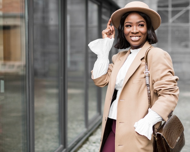 Smiley fashionable woman posing with copy space