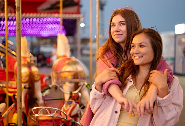 Smiley female friends at the amusement park