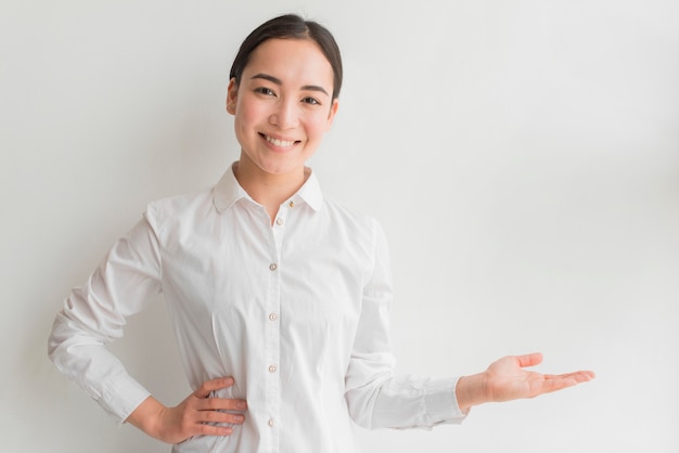 Smiley female with hand presenting