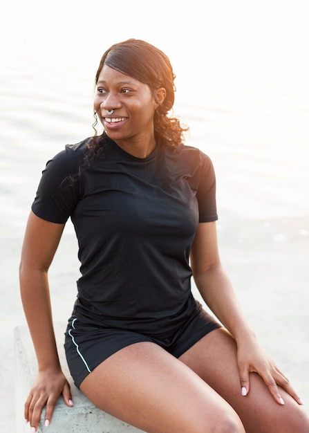 Smiley fit woman posing outdoors