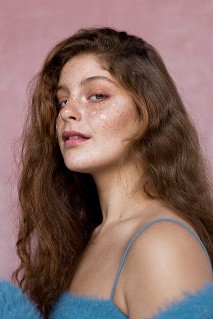 Smiley freckled woman with white flowers on her face