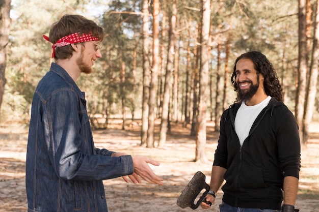 Free Photo smiley friends conversing outdoors over barbecue