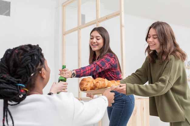 Smiley friends having snacks at home