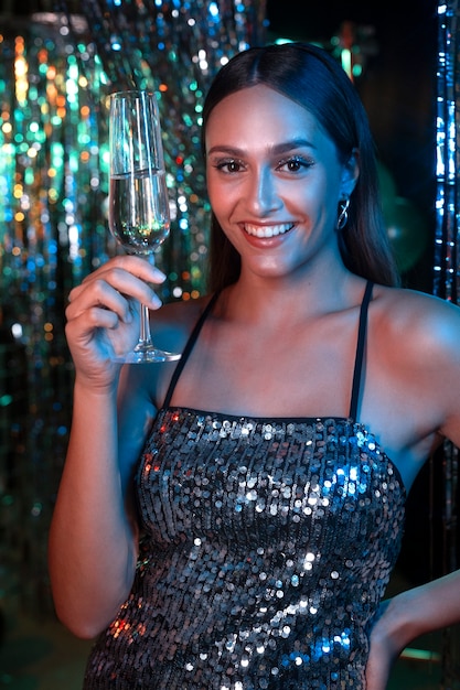 Smiley girl holding drink front view