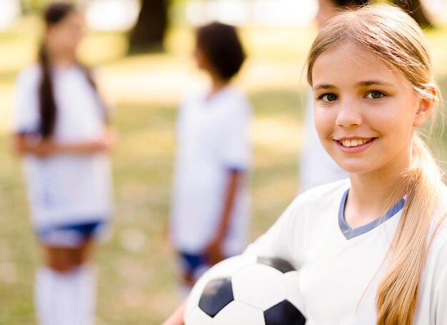 Smiley girl holding a football