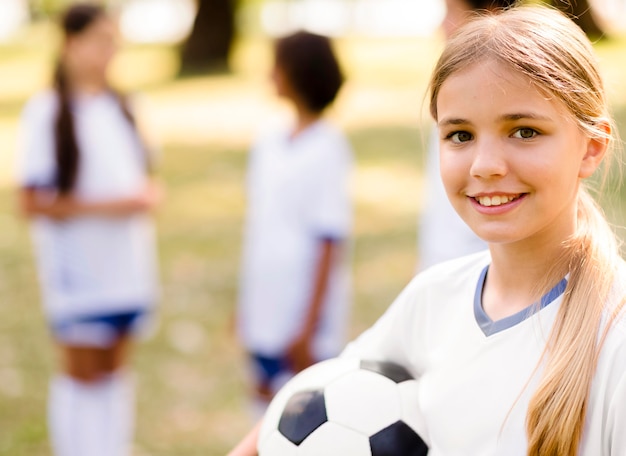 Smiley girl holding a football