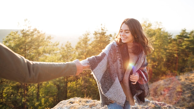 Smiley girl holding her boyfriends hand