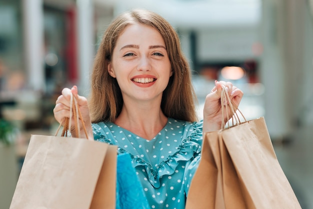 Smiley girl holding shopping bags