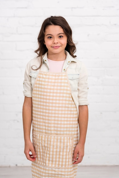 Smiley girl posing with white brick background